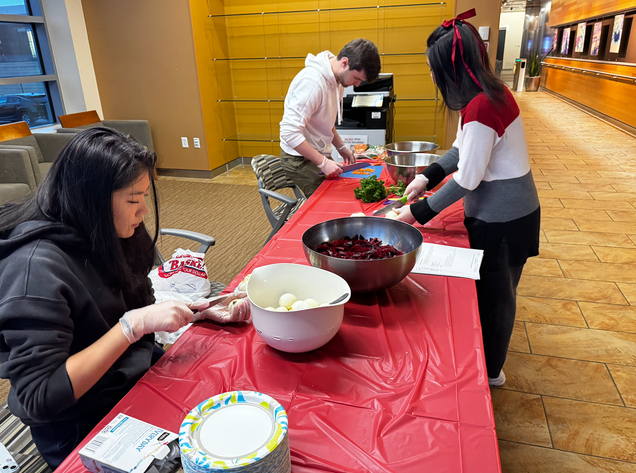 Three students are preparing the ingredients for the jardineras. Ashly Estrada (on the right) and Natalie Yu (on the left), both are Sargent Choice Student Ambassadors. Aiden Heala is in the background cutting carrots.